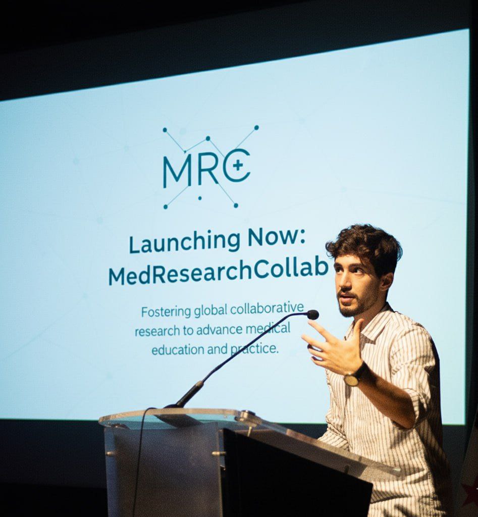 Youssef Ahmed speaking at a podium